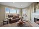 Comfortable living room with fireplace, large windows, and scenic views at 7645 Fox Creek Trl, Franktown, CO 80116