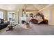 Luxurious main bedroom with a cozy fireplace, sitting area, and elegant furnishings at 7645 Fox Creek Trl, Franktown, CO 80116