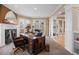 Cozy office with fireplace, built-in shelving, and vintage desk at 7645 Fox Creek Trl, Franktown, CO 80116