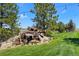 Unique water feature with a vintage truck, rock landscaping, and string lights at 7645 Fox Creek Trl, Franktown, CO 80116