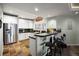 Modern wet bar features stainless steel appliances, granite countertops, and seating at 7645 Fox Creek Trl, Franktown, CO 80116