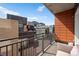 Balcony view features surrounding urban buildings with outdoor seating, perfect for relaxing and enjoying the city scenery at 1475 Delgany St # 307, Denver, CO 80202