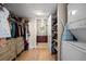 Spacious walk-in closet with custom shelving, built-in drawers, and convenient laundry, offering ample storage and organization at 1475 Delgany St # 307, Denver, CO 80202