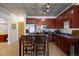 Modern kitchen featuring wood cabinets, stainless steel appliances, and a dining table for four at 1475 Delgany St # 307, Denver, CO 80202