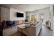 Inviting living room with concrete ceiling, modern furniture, and large TV for entertaining at 1475 Delgany St # 307, Denver, CO 80202