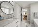 Bright bathroom with marble countertops, contemporary fixtures, and a view into the main bedroom at 1150 S Forest St, Denver, CO 80246