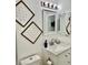 Charming bathroom with modern vanity, decorative wall art, and updated fixtures at 180 S Nome St, Aurora, CO 80012