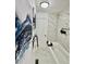 Stylish bathroom showcasing marble tiling, modern art, and a soaking tub at 180 S Nome St, Aurora, CO 80012