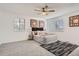 Cozy bedroom with a ceiling fan, carpet floors, and two windows that bring in plenty of natural light at 180 S Nome St, Aurora, CO 80012