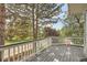 Relaxing outdoor deck with wooden railings, offering scenic views of lush greenery and neighborhood surroundings at 180 S Nome St, Aurora, CO 80012