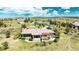 Aerial view of home featuring clay tile roof, stone chimney and gorgeous views at 8611 Coachlight Way, Littleton, CO 80125