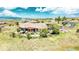 Estate Home with clay tile roof, covered patio and lush surroundings at 8611 Coachlight Way, Littleton, CO 80125