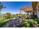 Backyard patio area with pergola, lovely stone landscaping, and mountain views at 8611 Coachlight Way, Littleton, CO 80125