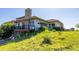 A grassy backyard with a stone chimney, patio and lovely greenery at 8611 Coachlight Way, Littleton, CO 80125