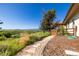 Backyard with native grasses, stepping stone path, wooden fence and gorgeous views at 8611 Coachlight Way, Littleton, CO 80125