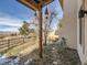 Backyard features a wooden pergola, gravel, and a view of the surrounding countryside at 8611 Coachlight Way, Littleton, CO 80125