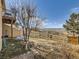 Backyard view with split rail fence and view of the mountains at 8611 Coachlight Way, Littleton, CO 80125