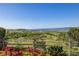 Expansive backyard with rolling hills and mountain views, framed by a wooden fence at 8611 Coachlight Way, Littleton, CO 80125