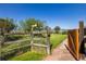 Gated access leading to lush green spaces and serene views from the backyard at 8611 Coachlight Way, Littleton, CO 80125