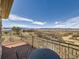 Enjoy the mountain view from this balcony with black iron railing and table set at 8611 Coachlight Way, Littleton, CO 80125