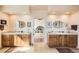Bathroom with separate vanity areas with wooden cabinets, tile countertop, and oval mirrors at 8611 Coachlight Way, Littleton, CO 80125