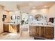 En-suite bathroom with double sink vanities and open doorway to the bedroom at 8611 Coachlight Way, Littleton, CO 80125