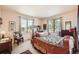 Bedroom with carpet floors and two windows that allows natural lighting to brighten the space at 8611 Coachlight Way, Littleton, CO 80125