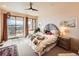 Bedroom with large windows, mountain views, sliding glass doors to deck and unique headboard at 8611 Coachlight Way, Littleton, CO 80125