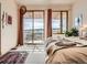 Bedroom with sliding glass doors to the patio and mountain views at 8611 Coachlight Way, Littleton, CO 80125