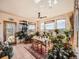 Bright dining area with many plants and a spectacular view at 8611 Coachlight Way, Littleton, CO 80125