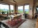 Bright dining area with large windows showcasing mountain views and stylish decor at 8611 Coachlight Way, Littleton, CO 80125