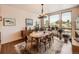 Bright dining room featuring a large window with scenic views, a chandelier and neutral paint at 8611 Coachlight Way, Littleton, CO 80125