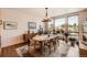 Dining room with a modern chandelier, a sideboard, and large windows at 8611 Coachlight Way, Littleton, CO 80125