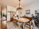 Charming dining room with hardwood floors, neutral paint, and stylish light fixture at 8611 Coachlight Way, Littleton, CO 80125