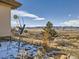 Exterior view with backyard and mountain views in the background at 8611 Coachlight Way, Littleton, CO 80125