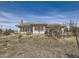 Rear exterior view of a large home with mountain views in the distance at 8611 Coachlight Way, Littleton, CO 80125