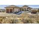 Inviting stucco home with two-car garage and circular driveway situated in scenic snowy landscape at 8611 Coachlight Way, Littleton, CO 80125