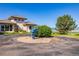 Landscaped circular driveway showcasing a large property with mountain views and blue sculpture at 8611 Coachlight Way, Littleton, CO 80125