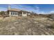 Rear exterior view of a large home with mountain views in the distance at 8611 Coachlight Way, Littleton, CO 80125