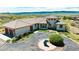 Elegant home boasts a circular driveway, tile roof, and stunning mountain views, perfect for luxurious living at 8611 Coachlight Way, Littleton, CO 80125