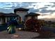Front exterior of home at dusk with landscape art and holiday lights at 8611 Coachlight Way, Littleton, CO 80125