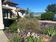 Landscaped front yard with rock beds and beautiful irises at 8611 Coachlight Way, Littleton, CO 80125