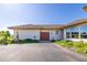 A three-car garage with a long driveway and some shrubbery at 8611 Coachlight Way, Littleton, CO 80125