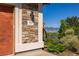 Close up on the house number against a stone wall and a charming wooden deer decoration at 8611 Coachlight Way, Littleton, CO 80125
