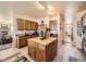 Spacious kitchen with custom wood cabinets, a central island and modern appliances at 8611 Coachlight Way, Littleton, CO 80125