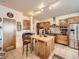 Well-appointed kitchen featuring stainless steel appliances, a central island and tile floors at 8611 Coachlight Way, Littleton, CO 80125