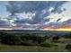 Expansive scenic views from the property at dusk with colorful sky at 8611 Coachlight Way, Littleton, CO 80125