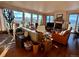 Bright living room with hardwood floors, large windows offering scenic views, and comfortable furnishings at 8611 Coachlight Way, Littleton, CO 80125