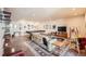 Spacious living room with a couch, coffee table, pool table, and lots of pictures on the walls at 8611 Coachlight Way, Littleton, CO 80125