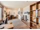 Open living room/office with hardwood floors, custom built-in shelving, and natural light at 8611 Coachlight Way, Littleton, CO 80125